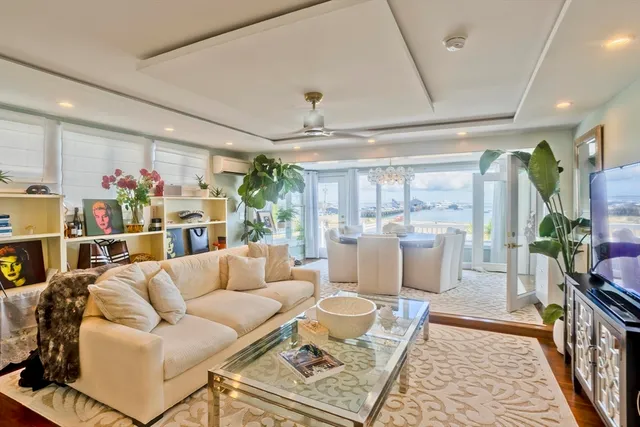 a room with lots of wooden furniture and a large window