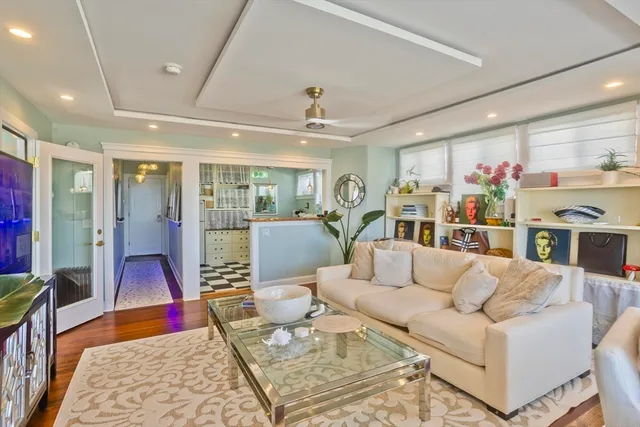 a living room with furniture fireplace and a large mirror