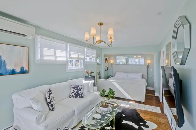 a living room with fireplace furniture and a wooden floor