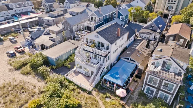 an aerial view of multiple houses with a yard