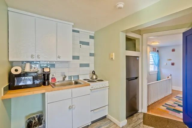 a kitchen with appliances cabinets and a sink