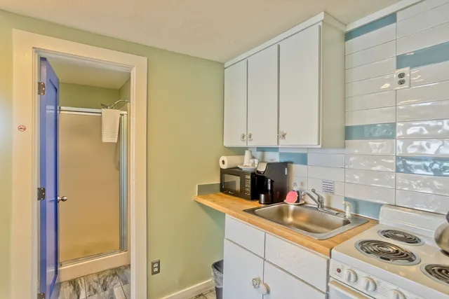 a view of a room with furniture and wooden floor