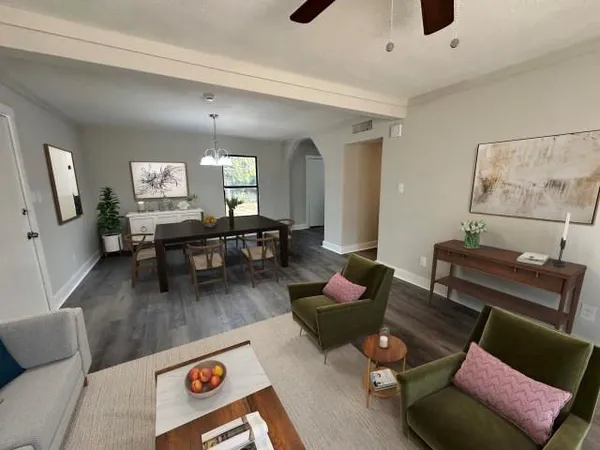 a living room with furniture and wooden floor