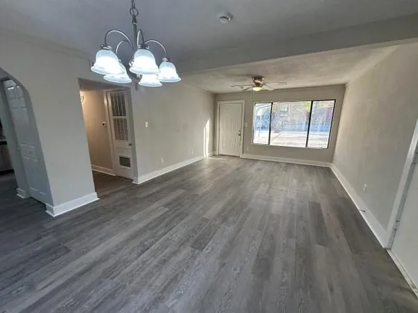 a view of a room with wooden floor and chandelier