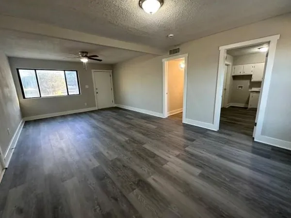 wooden floor in an empty room with a window