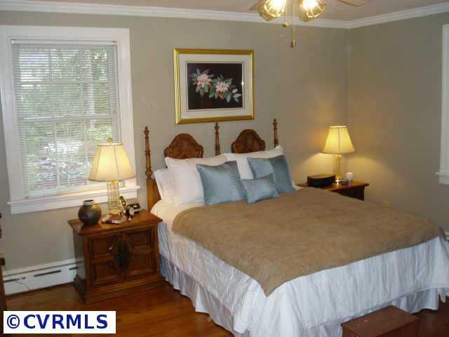 3612 Sherbrook Road Richmond, VA 23235 - Photo 9 of 10 Other - Master bedroom with hardwood floors, ceiling fan, decorative mirrored closet and full bath