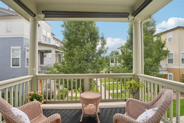 a view of a chair and tables in the balcony