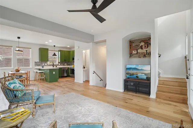 a living room with furniture and view of kitchen