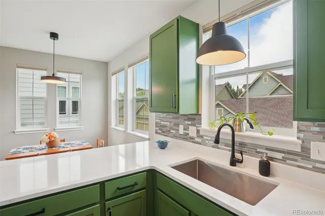 a kitchen with a sink and a wooden floor