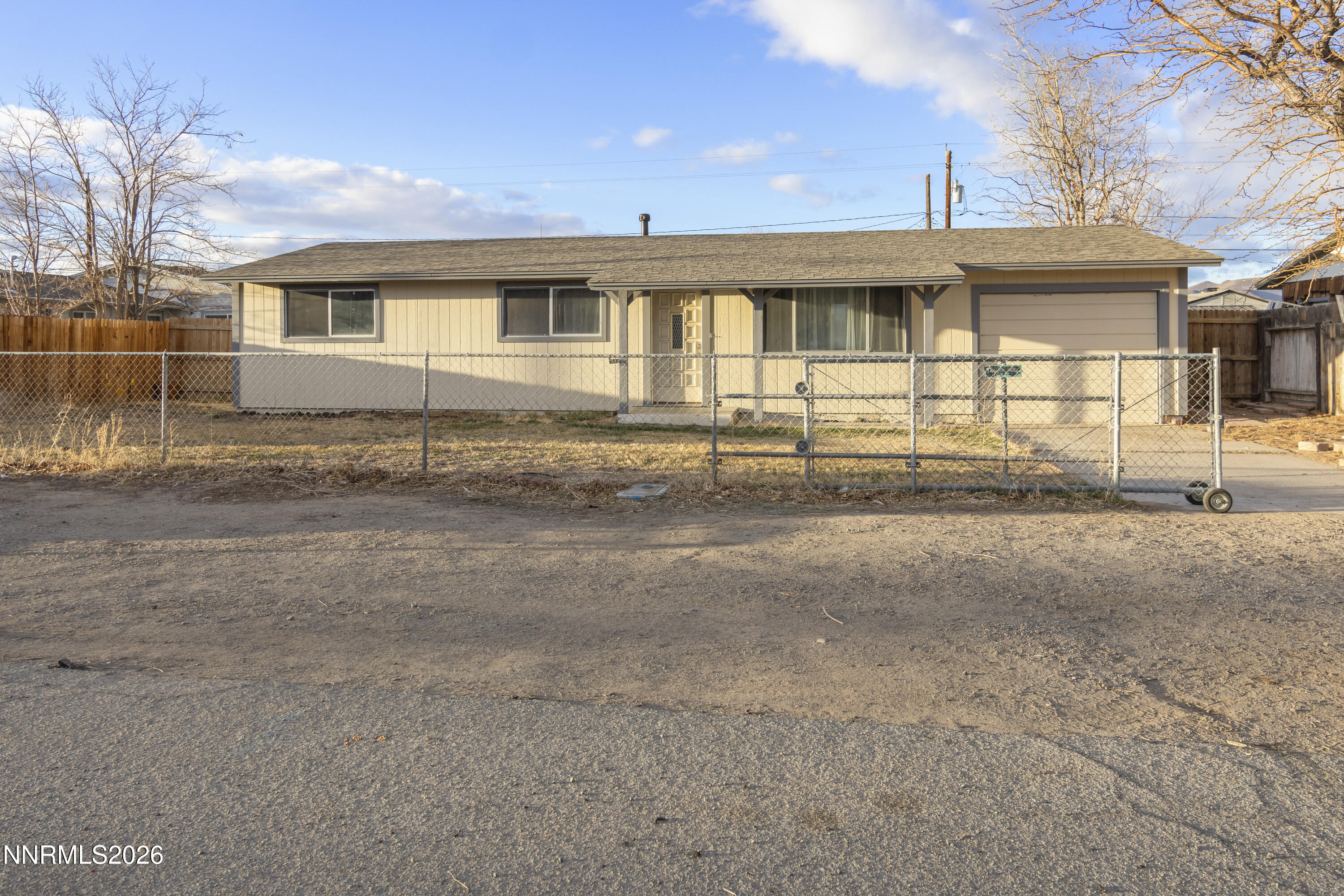 a front view of a house with a road