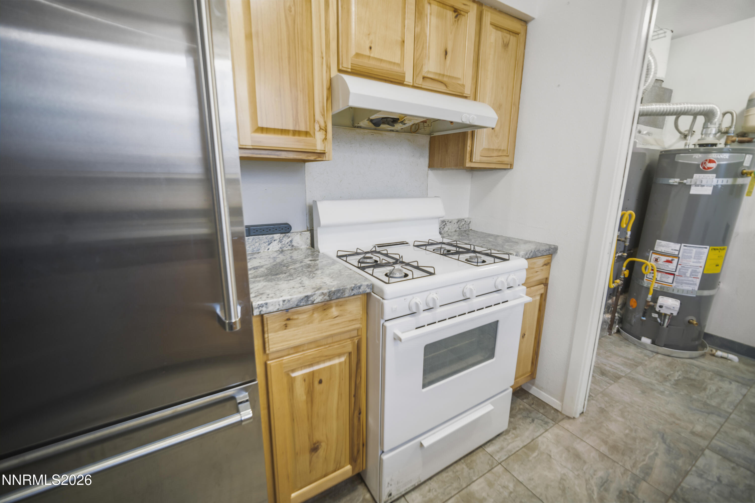 150 McCart Street Fernley, NV 89408 - Photo 11 of 28 a kitchen with stainless steel appliances granite countertop a stove and a refrigerator