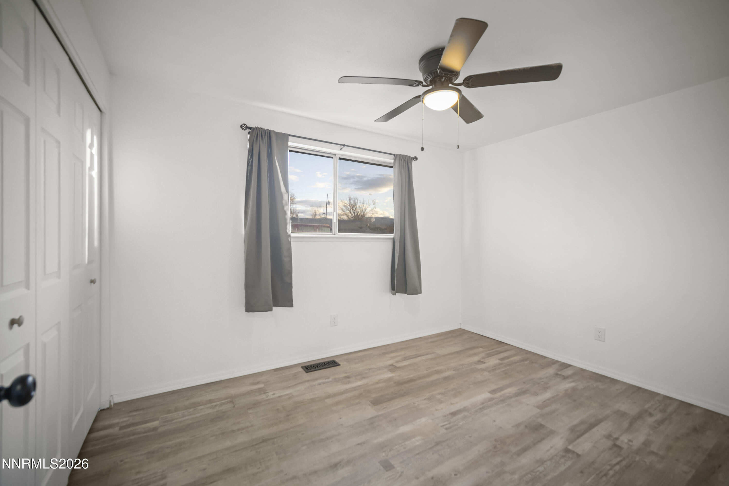 150 McCart Street Fernley, NV 89408 - Photo 13 of 28 a view of a room with a ceiling fan and a window