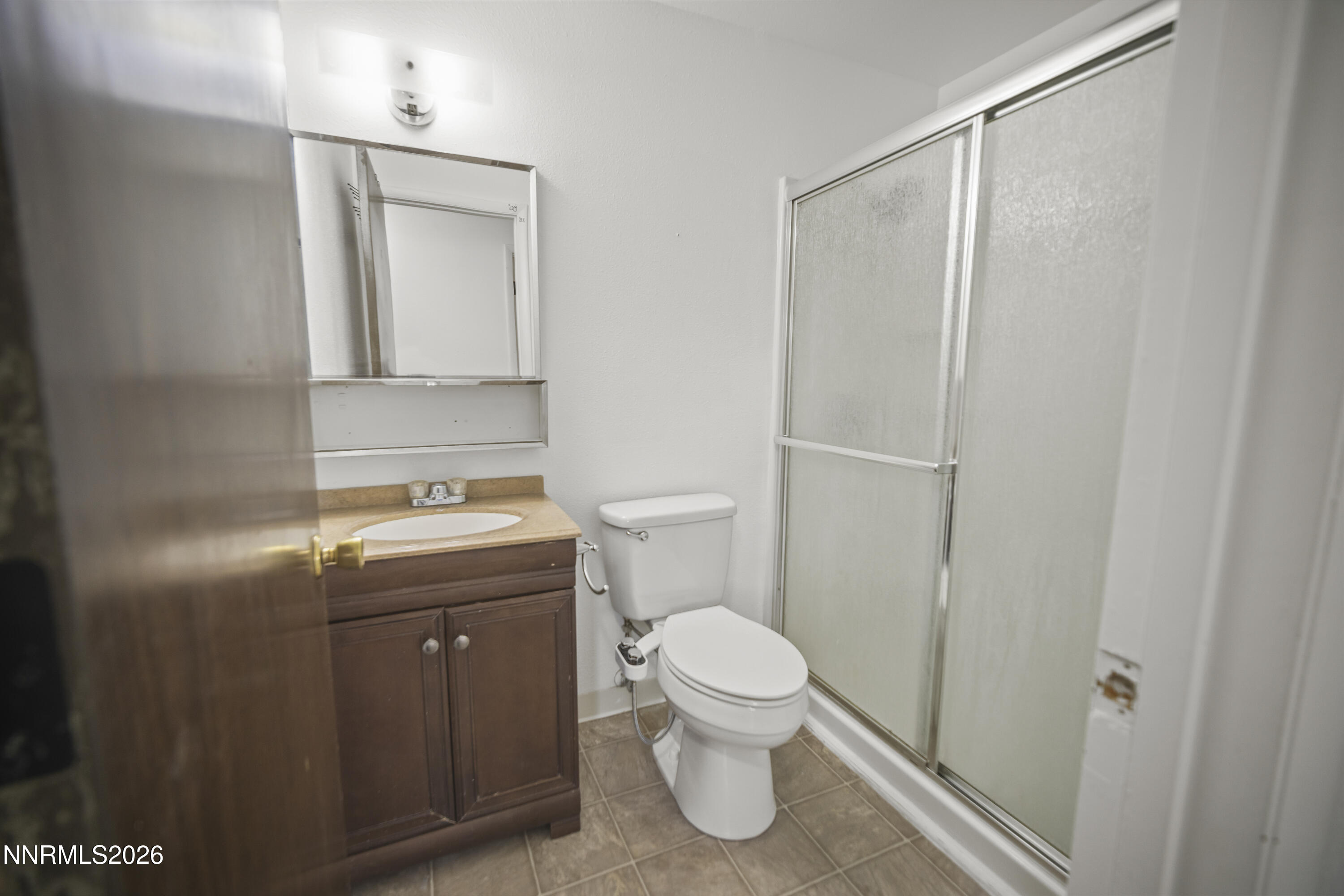 150 McCart Street Fernley, NV 89408 - Photo 16 of 28 a bathroom with a granite countertop sink toilet and shower