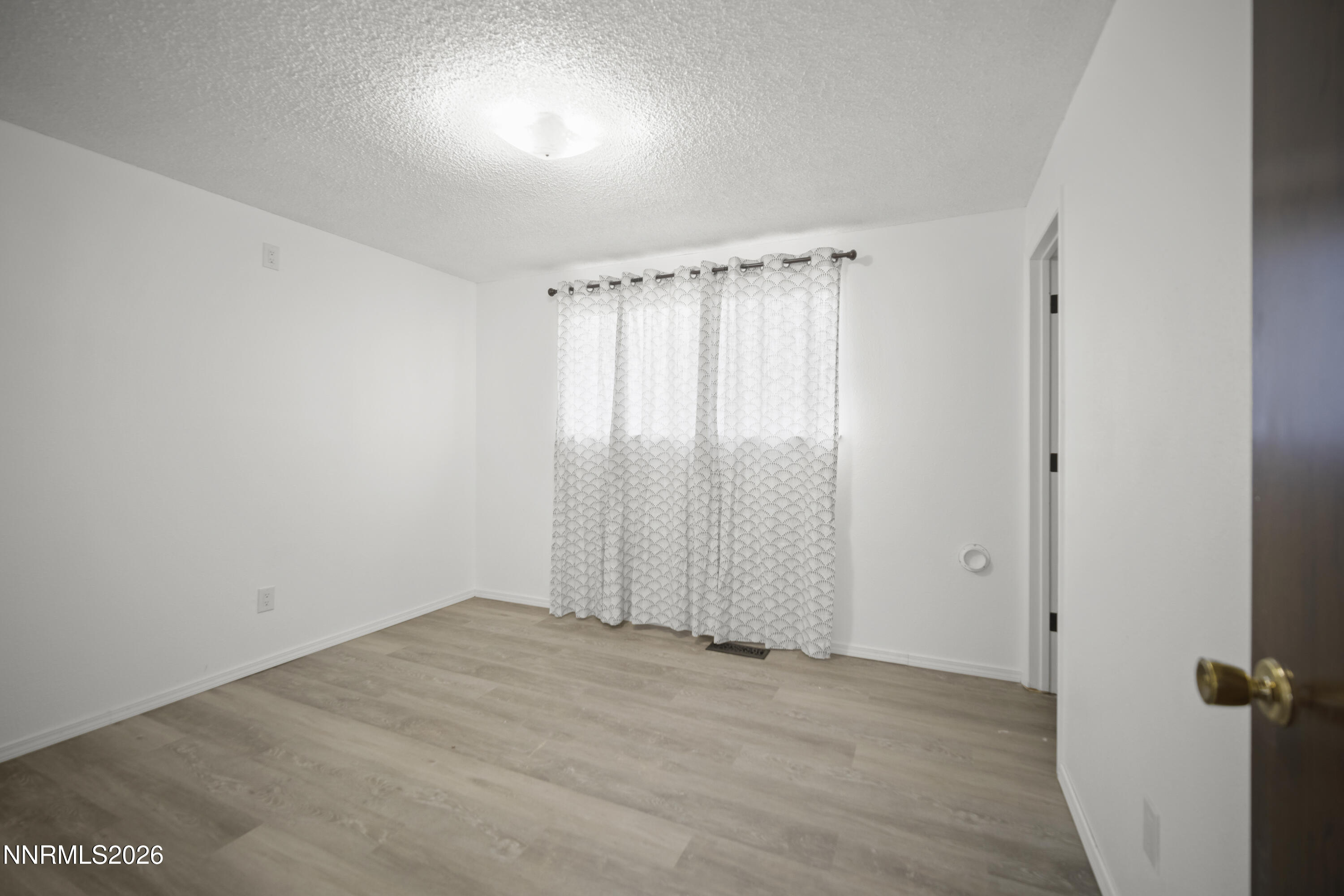 150 McCart Street Fernley, NV 89408 - Photo 18 of 28 an empty room with a empty space and windows
