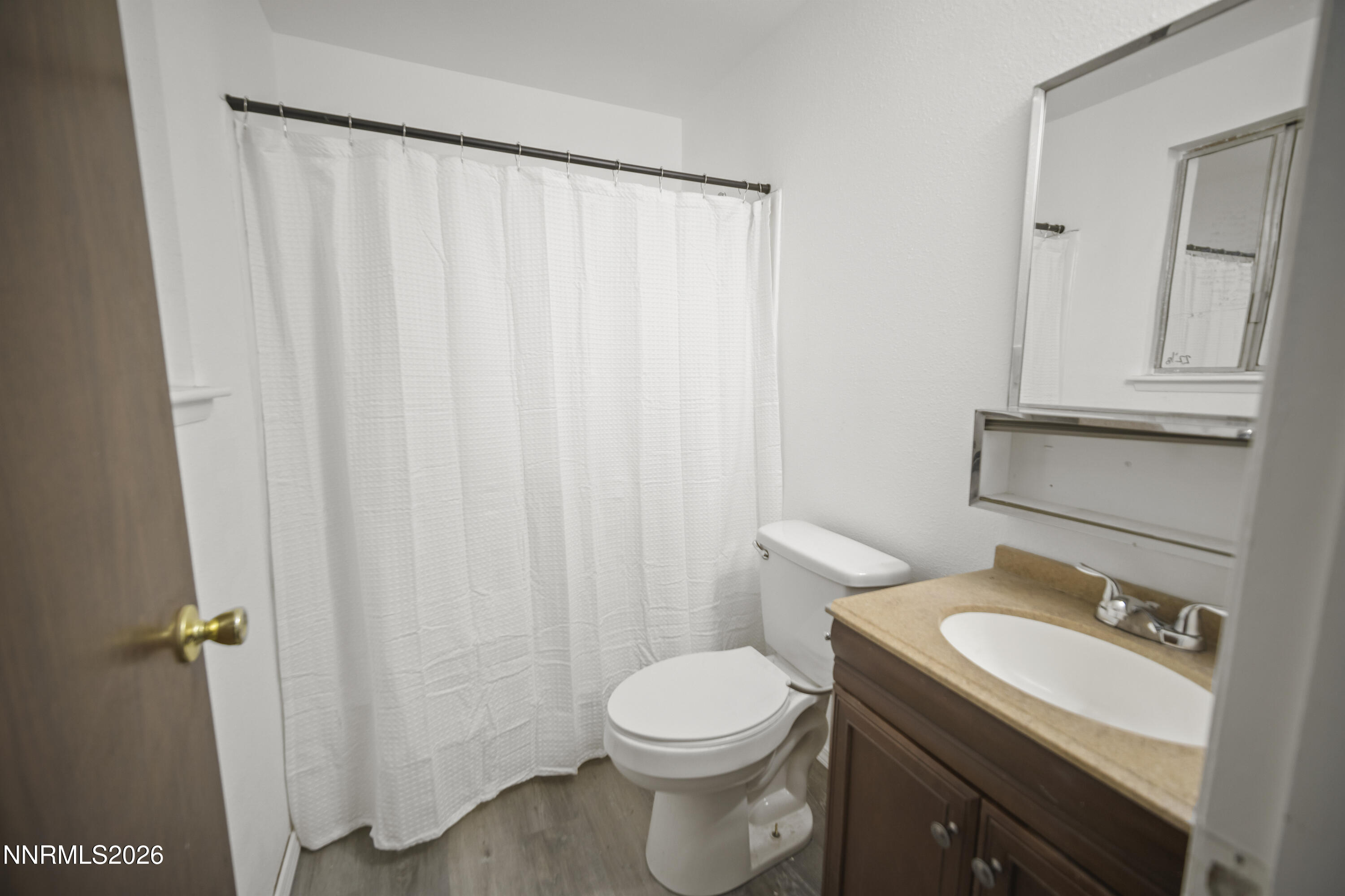 150 McCart Street Fernley, NV 89408 - Photo 20 of 28 a bathroom with a sink a toilet and shower curtain