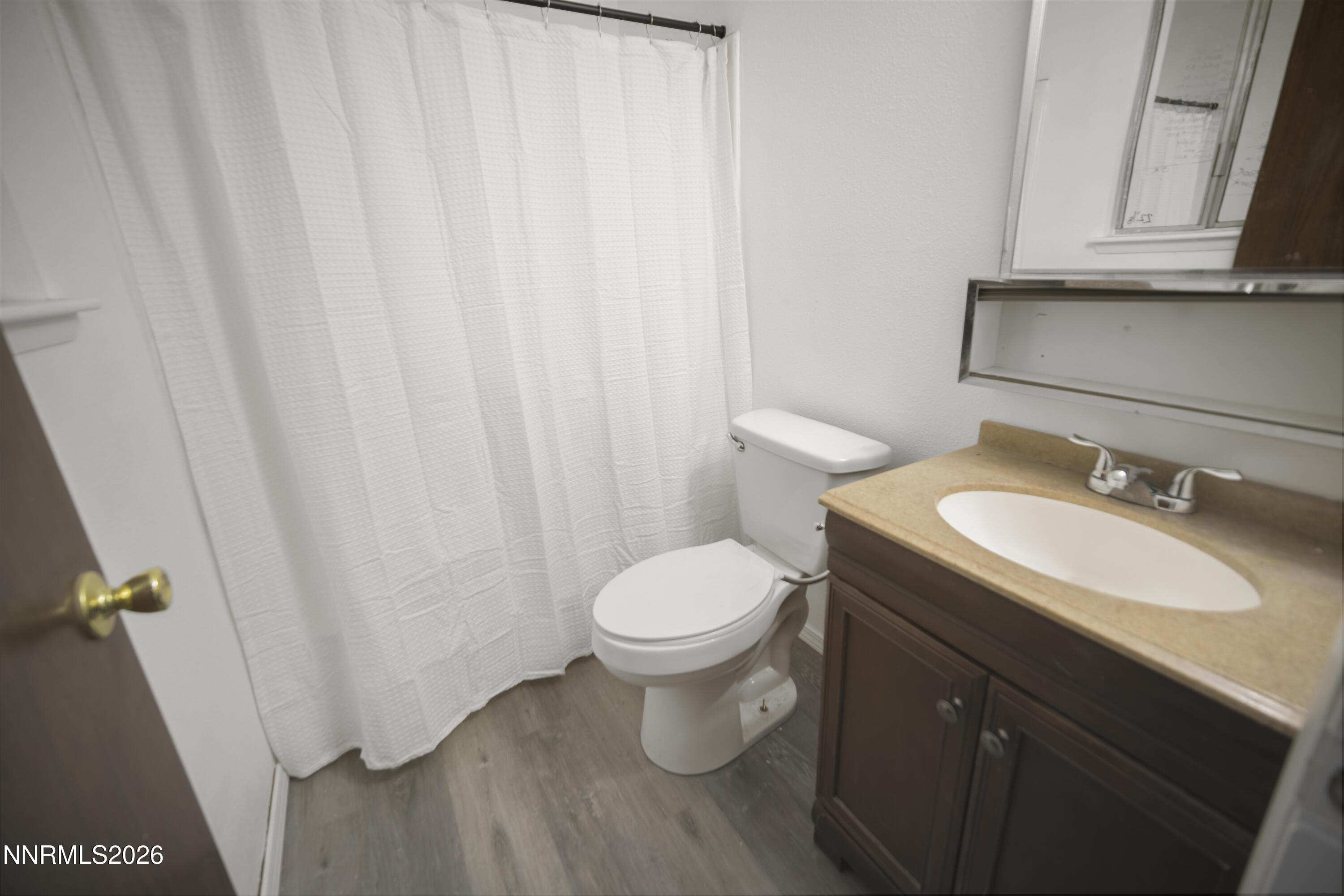 150 McCart Street Fernley, NV 89408 - Photo 22 of 28 a bathroom with a sink a toilet and shower curtain