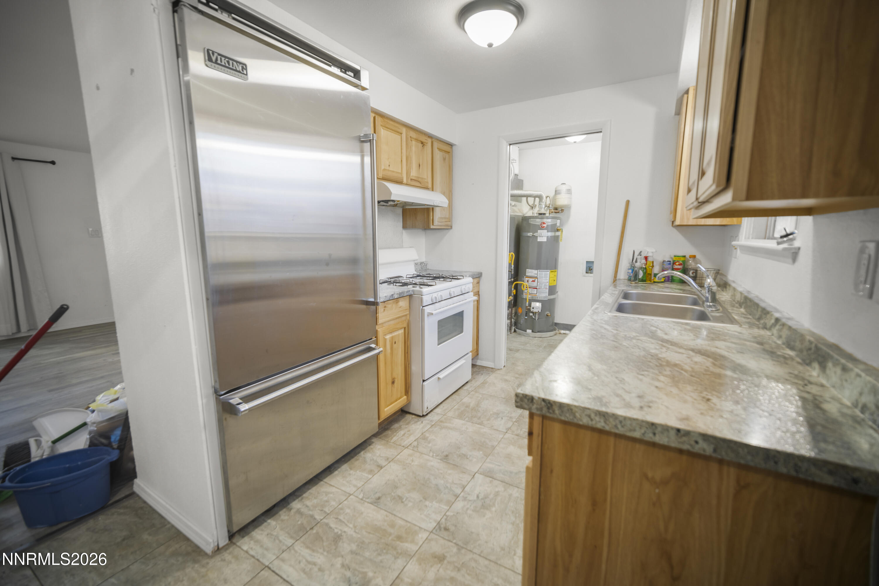 150 McCart Street Fernley, NV 89408 - Photo 5 of 28 a kitchen with granite countertop a refrigerator and a sink