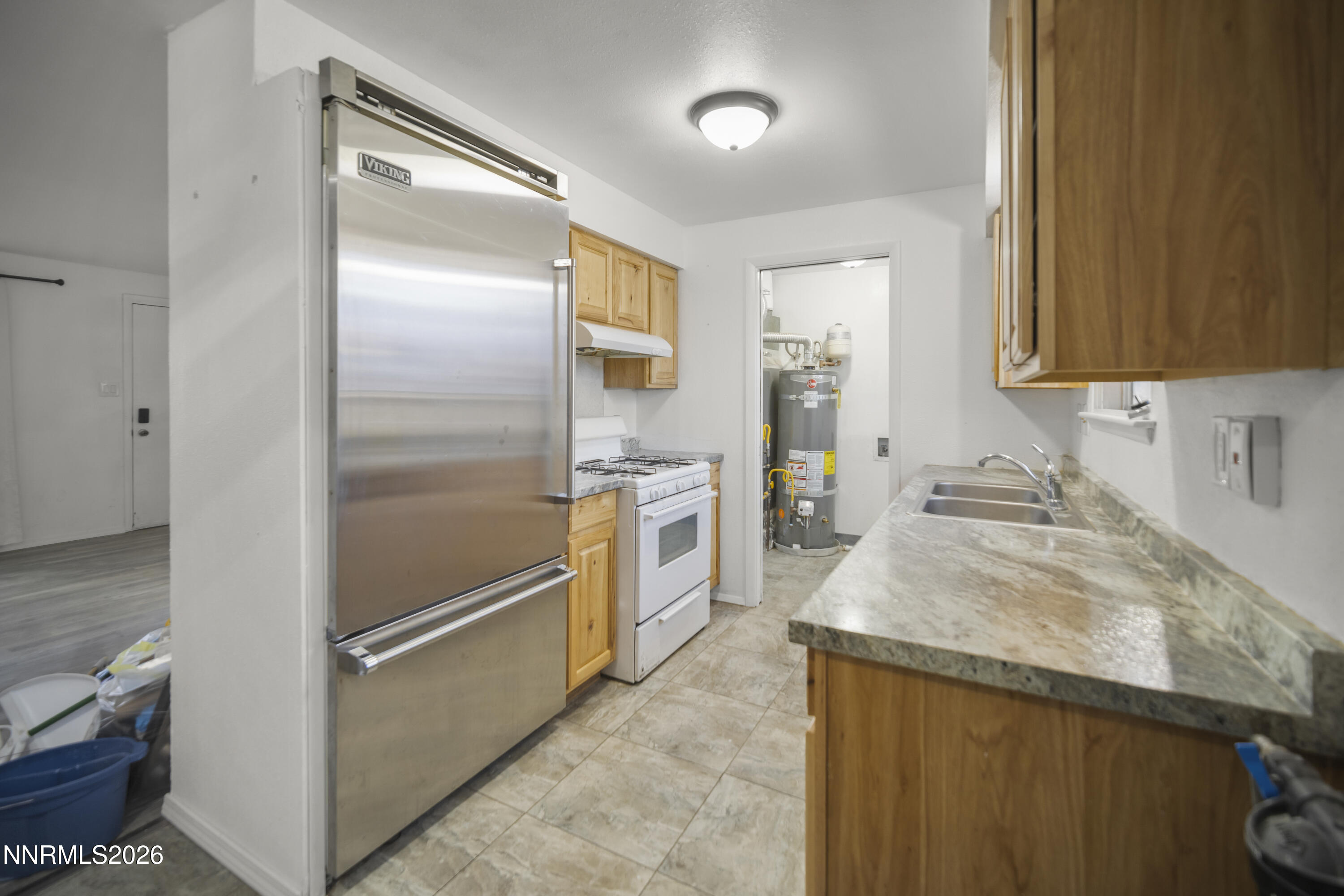 150 McCart Street Fernley, NV 89408 - Photo 6 of 28 a kitchen with granite countertop a refrigerator and a sink