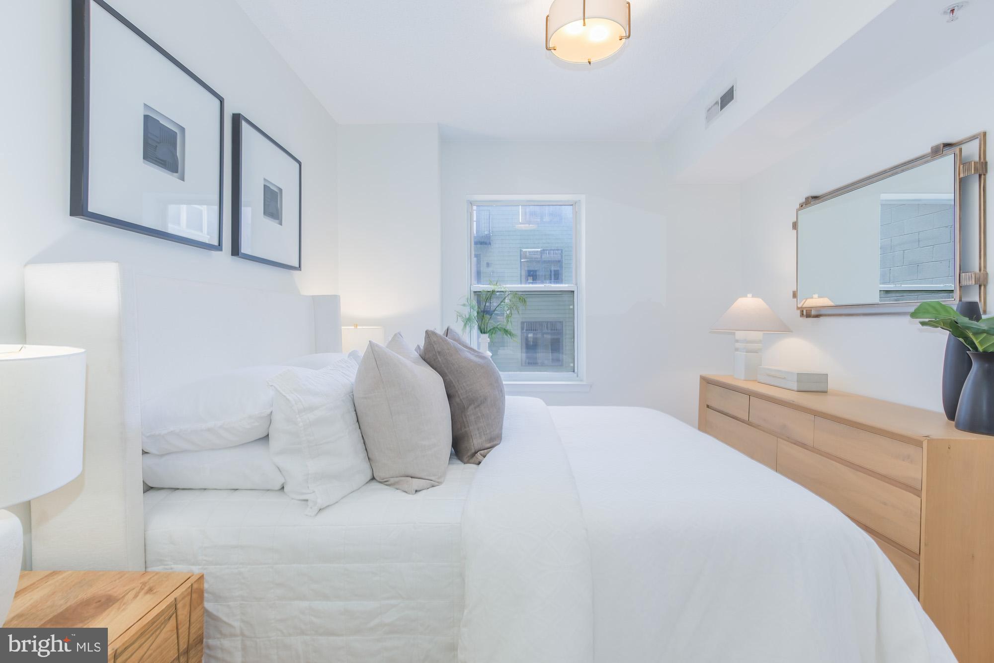 1111 11th Street Northwest, Unit 309 Washington, DC 20001 - Photo 12 of 18 a bedroom with a bed and a couch