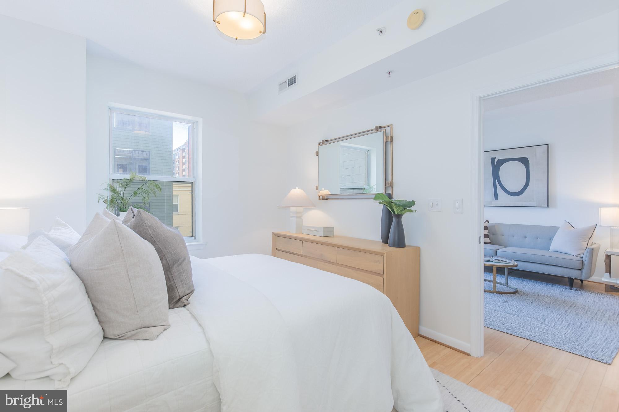 1111 11th Street Northwest, Unit 309 Washington, DC 20001 - Photo 13 of 18 a bedroom with a bed and windows