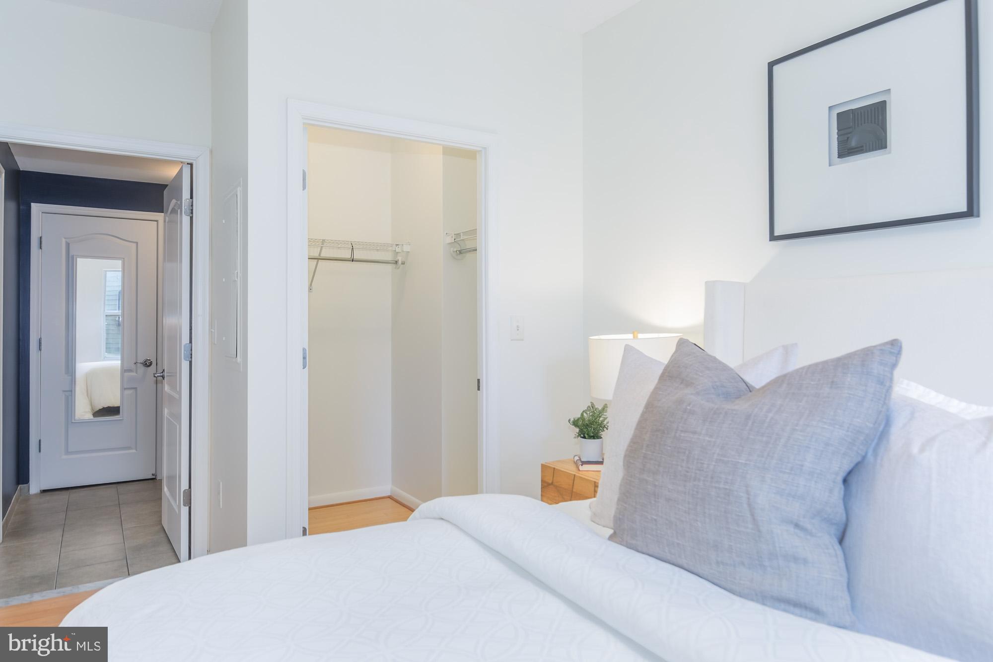 1111 11th Street Northwest, Unit 309 Washington, DC 20001 - Photo 14 of 18 a bedroom with a bed and a couch