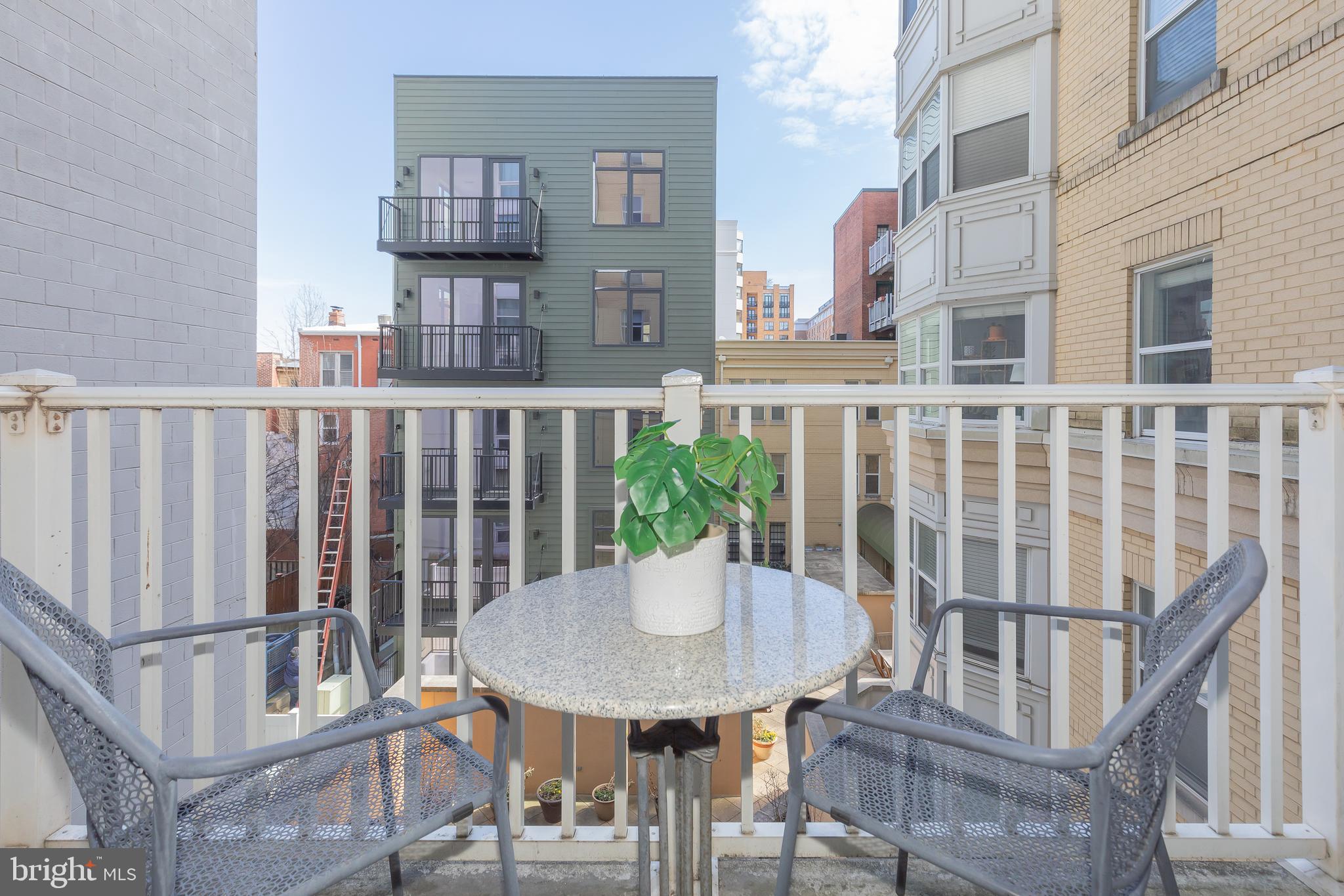 1111 11th Street Northwest, Unit 309 Washington, DC 20001 - Photo 17 of 18 a view of a balcony with table and chairs
