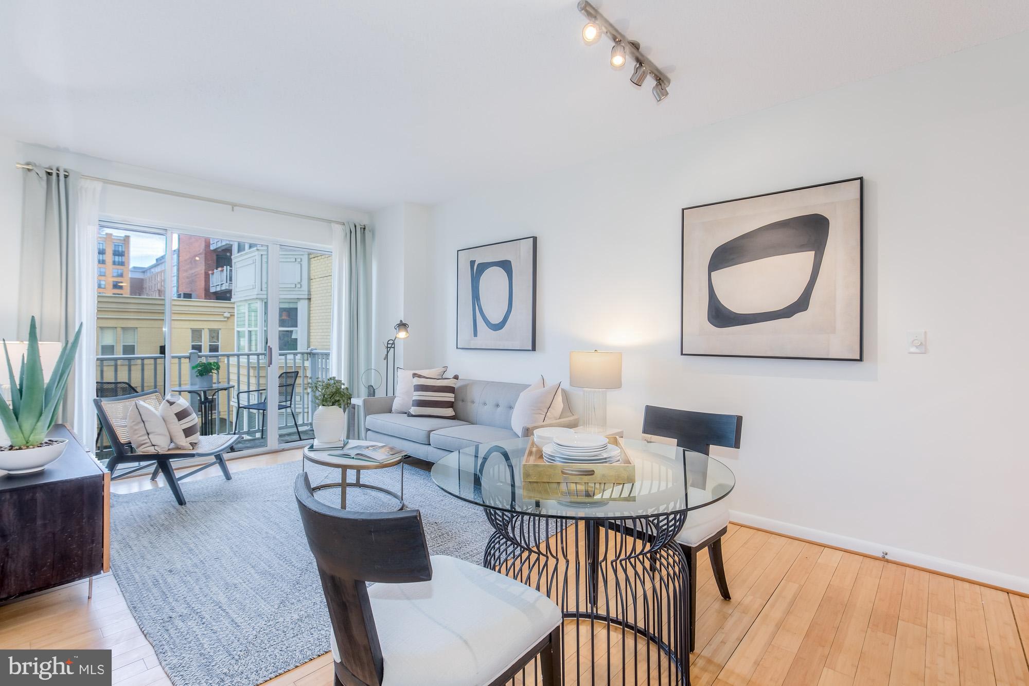 1111 11th Street Northwest, Unit 309 Washington, DC 20001 - Photo 4 of 18 a living room with furniture and a wooden floor