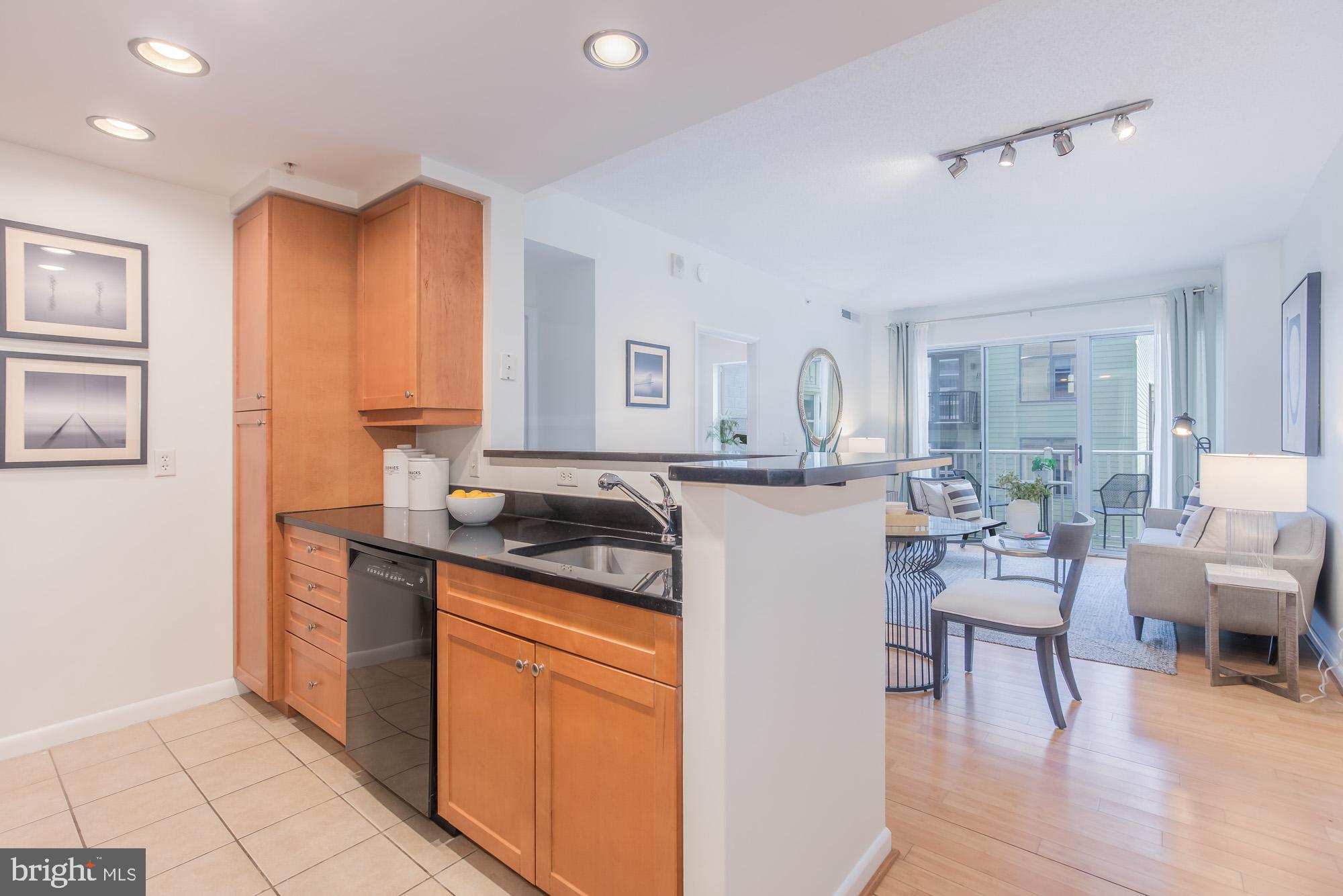 1111 11th Street Northwest, Unit 309 Washington, DC 20001 - Photo 7 of 18 a kitchen with a sink cabinets and wooden floor