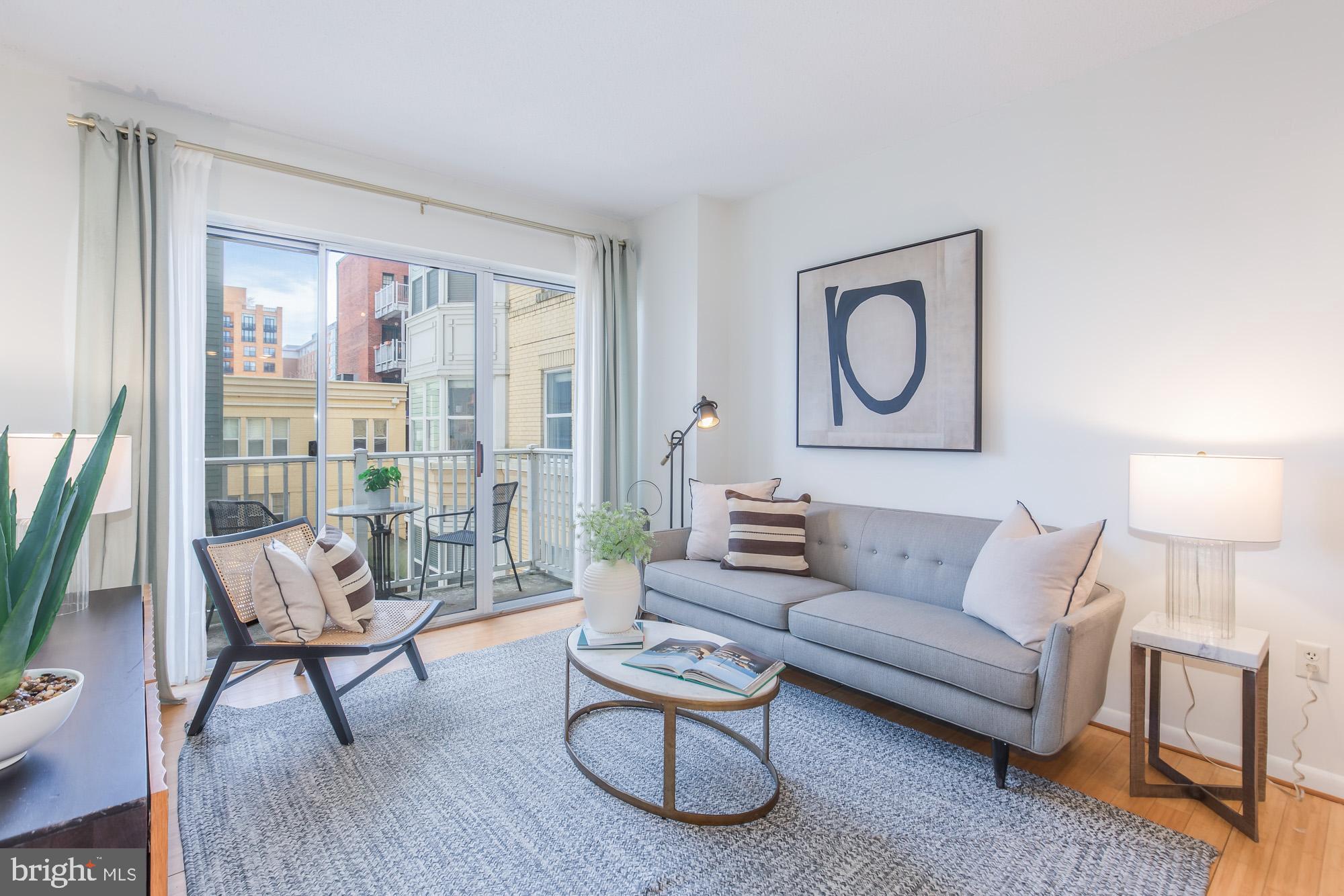 1111 11th Street Northwest, Unit 309 Washington, DC 20001 - Photo 8 of 18 a living room with furniture and a large window
