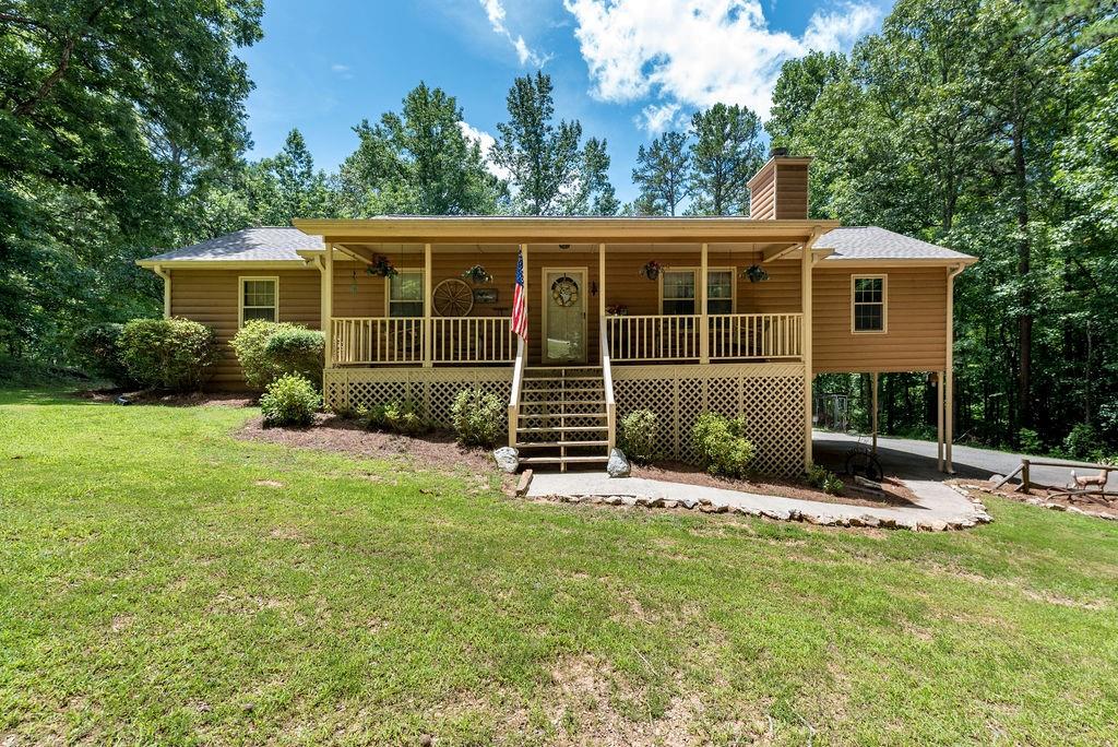 1911 Henderson Mountain Road Jasper, GA 30143 - Photo 1 of 1 a front view of a house with a yard table and chairs