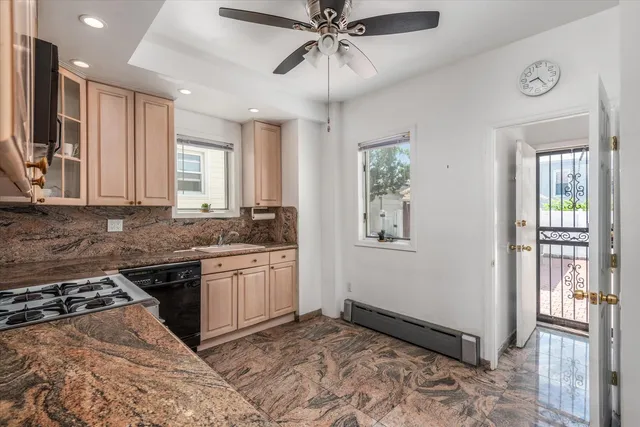a kitchen with stainless steel appliances granite countertop a stove a sink and a refrigerator
