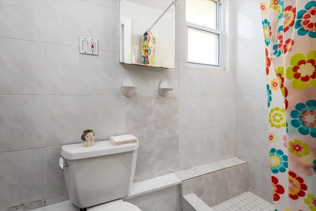 a bathroom with a sink a toilet and a shower curtain