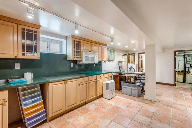 a kitchen with stainless steel appliances granite countertop a sink and cabinets