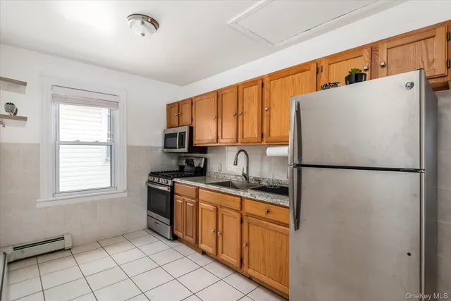a white refrigerator freezer sitting inside of a kitchen