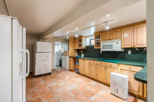 a large kitchen with cabinets and stainless steel appliances