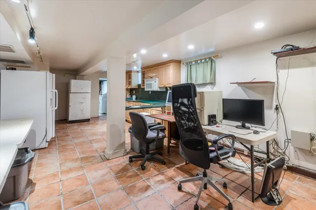 a white toilet sitting next to a white sink and vanity