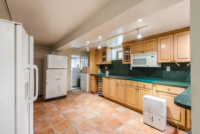 a large kitchen with cabinets and stainless steel appliances