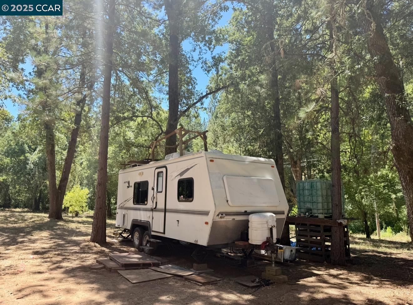 4578 Pretty Good Road Placerville, CA 95667 - Photo 8 of 25 a white house covered with tall trees