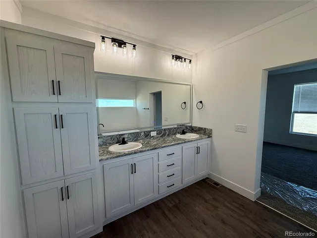 a bathroom with a double vanity sink and mirror