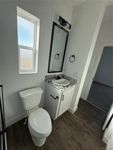 a white toilet sitting next to a bathroom sink