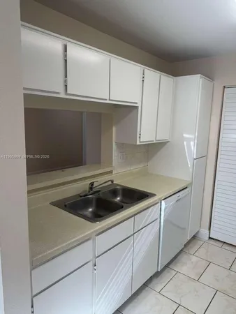 a kitchen with a sink and cabinets