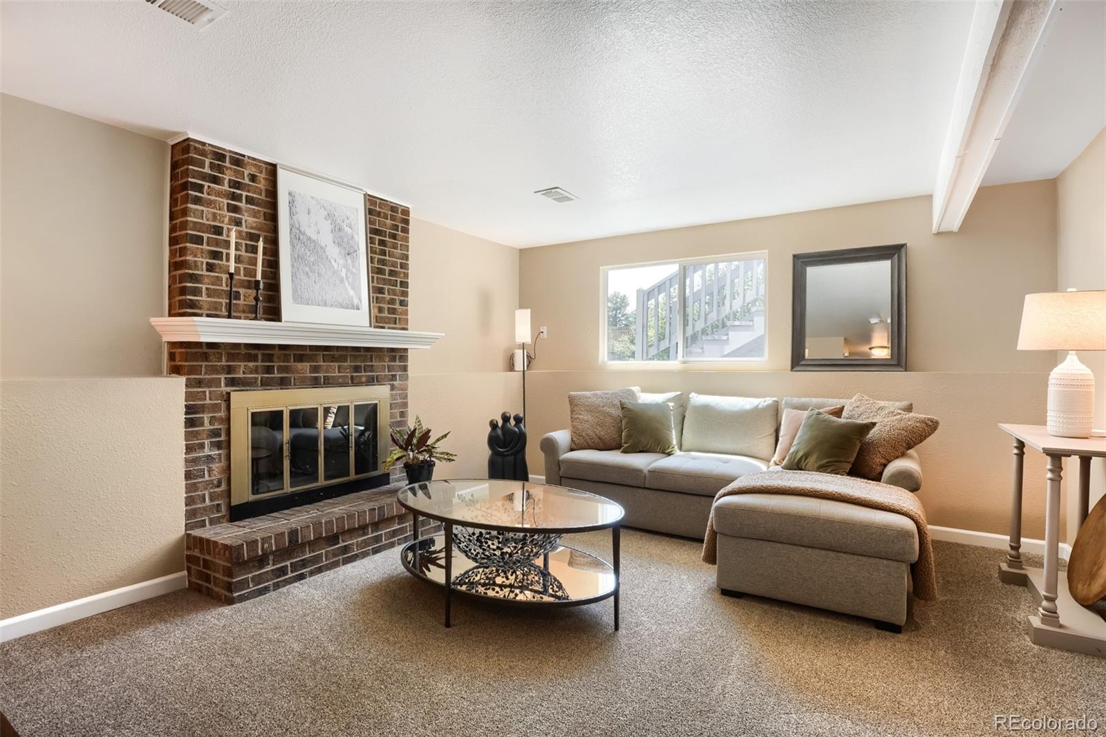 6551 South Albion Way Littleton, CO 80121 - Photo 16 of 37 a living room with furniture and a fireplace