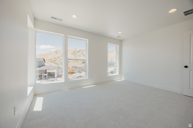 5902 Canyon Rim Road, Unit 620 Lehi, UT 84048 - Photo 55 of 78 Bright room featuring three large windows showcasing a mountain backdrop