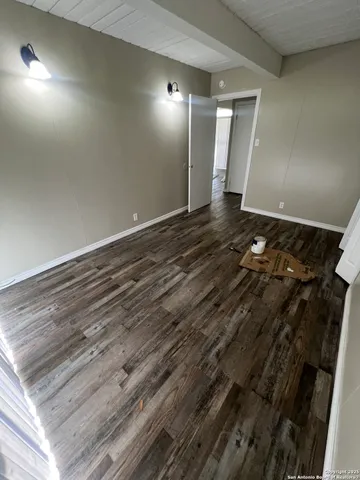 an empty room with wooden floor