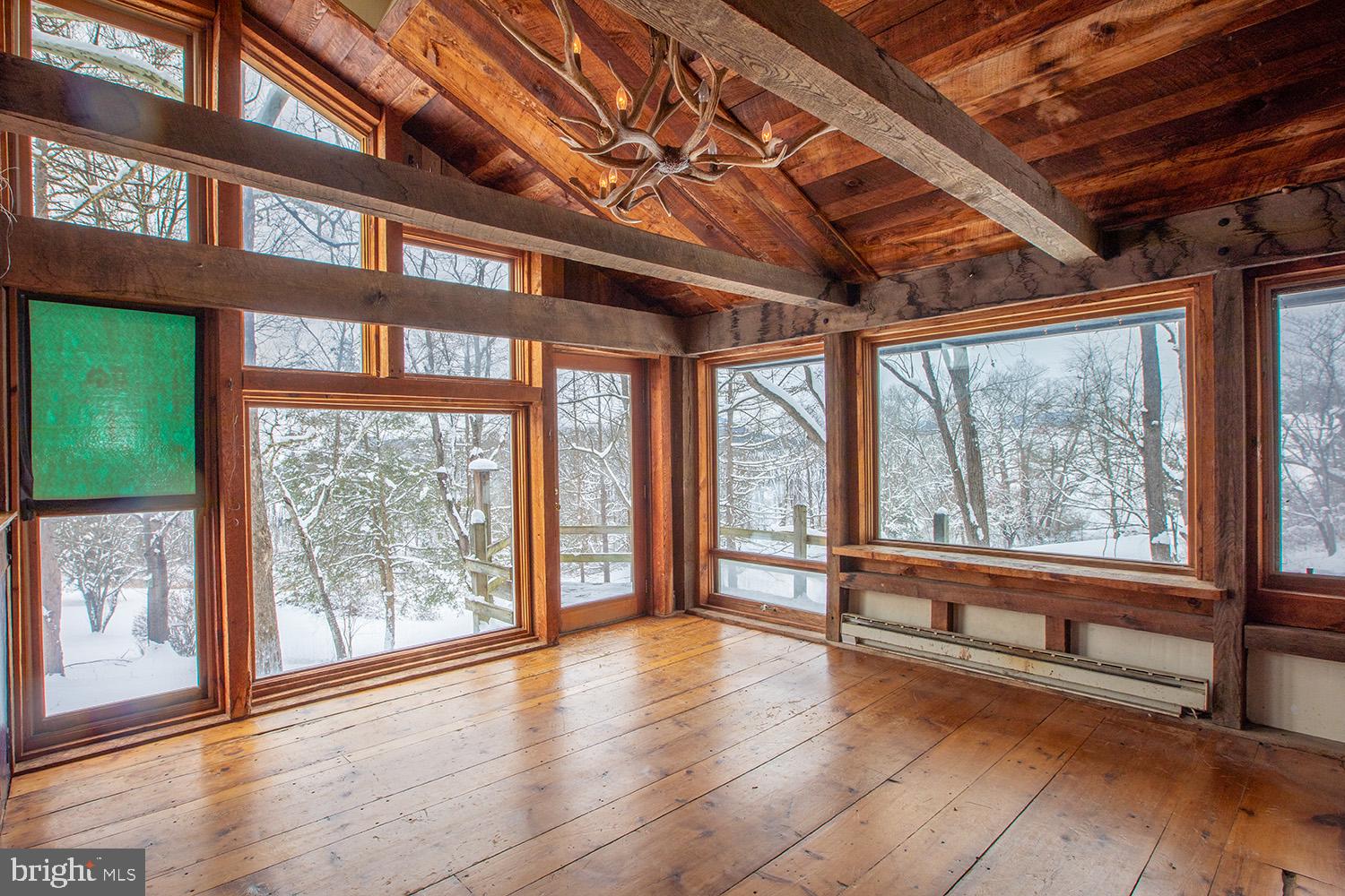 220 Dietrich Road Kempton, PA 19529 - Photo 15 of 90 a view of an empty room with wooden floor and a floor to ceiling window