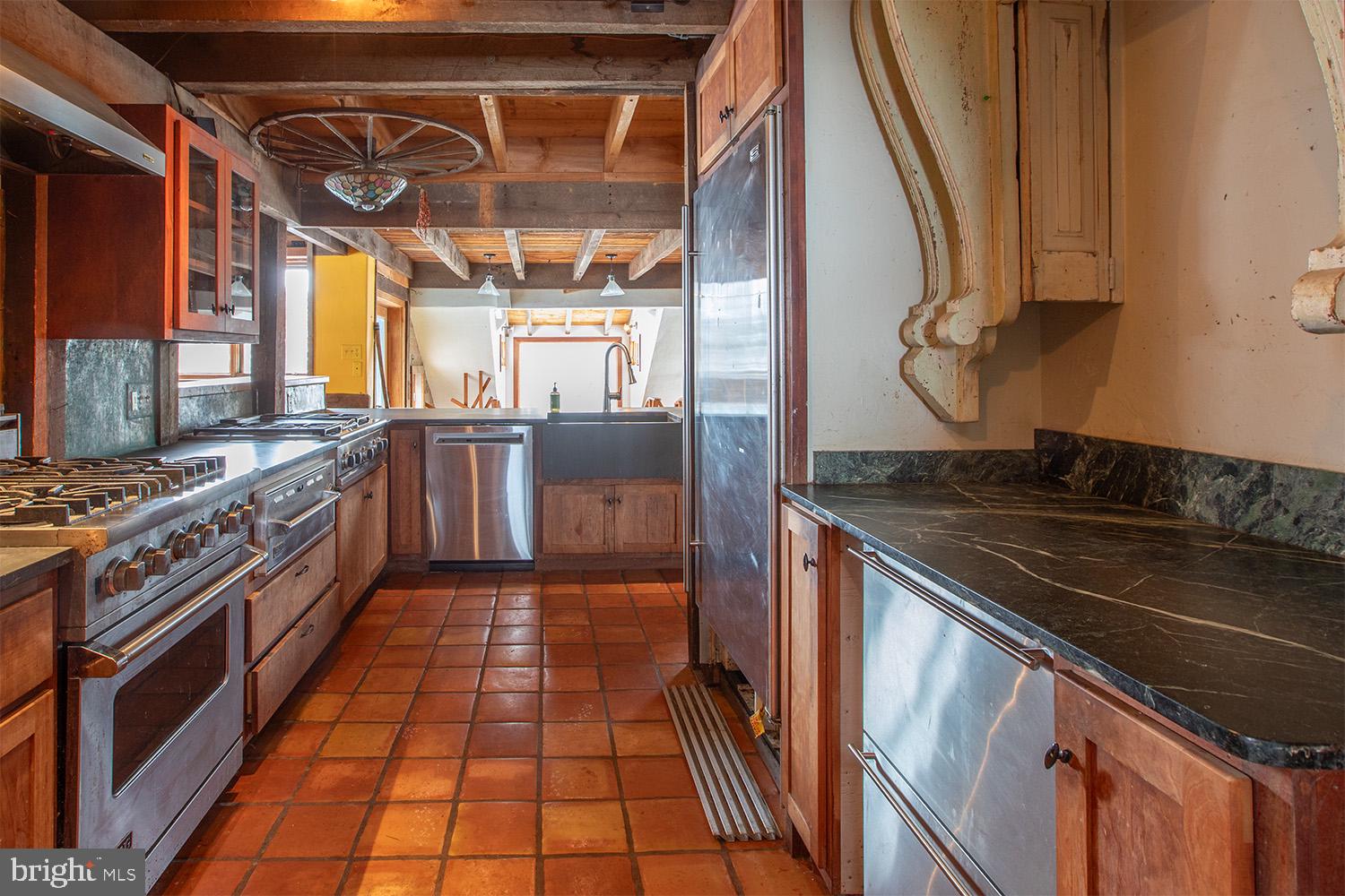 220 Dietrich Road Kempton, PA 19529 - Photo 22 of 90 a kitchen with stainless steel appliances granite countertop a stove a sink and a microwave