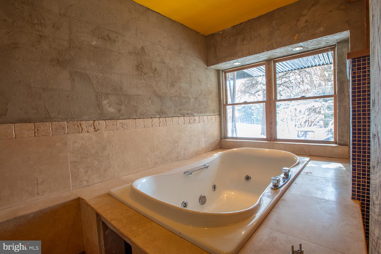 220 Dietrich Road Kempton, PA 19529 - Photo 49 of 90 a bath tub sitting in a bathroom next to a window