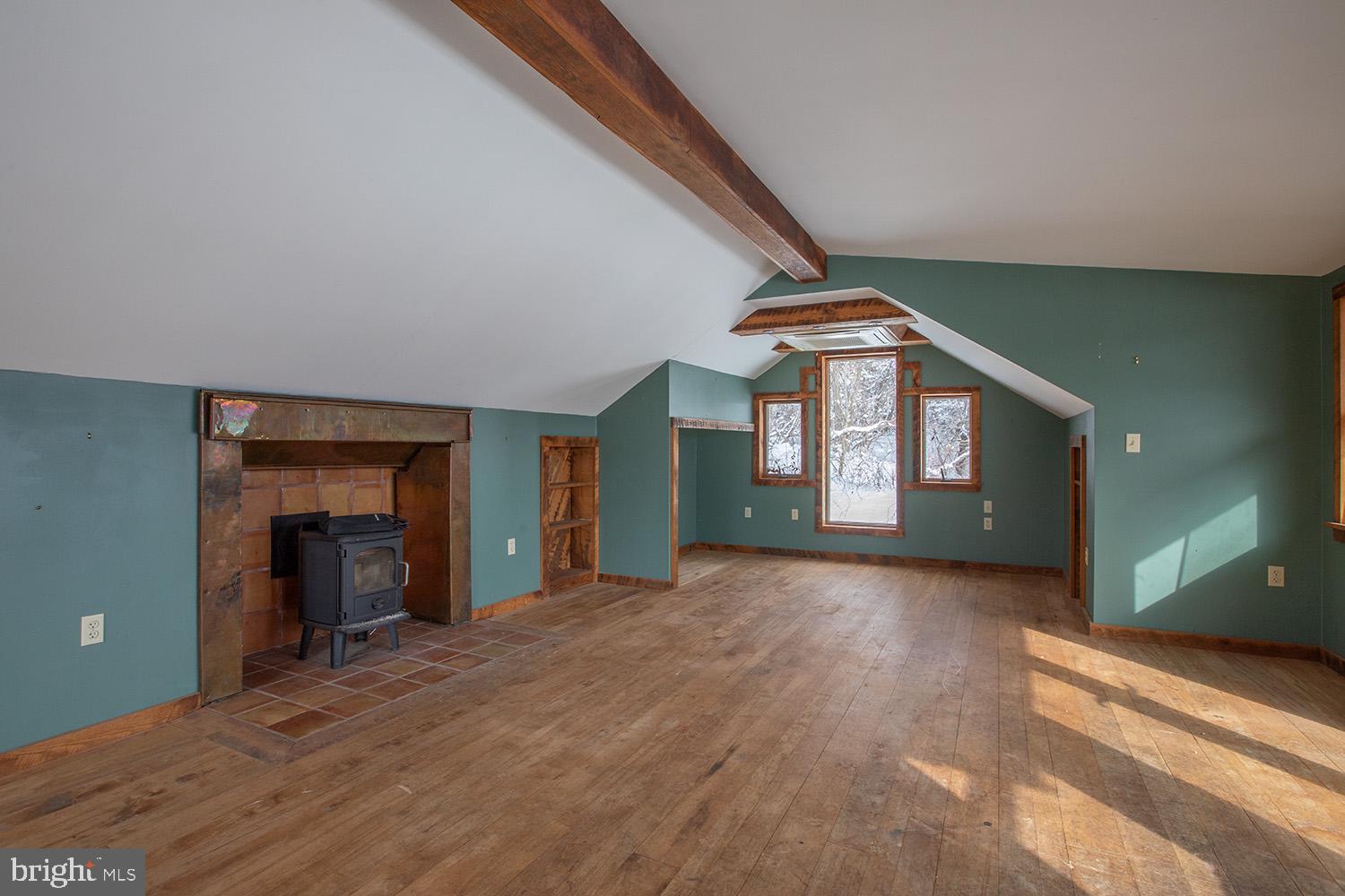 220 Dietrich Road Kempton, PA 19529 - Photo 64 of 90 a view of a hallway with wooden floor and a fireplace