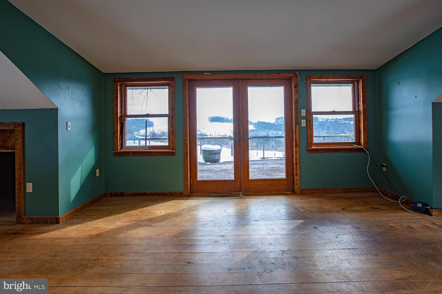 220 Dietrich Road Kempton, PA 19529 - Photo 65 of 90 an empty room with wooden floor and windows