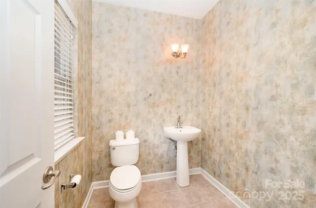 a white toilet sitting next to a shower curtain